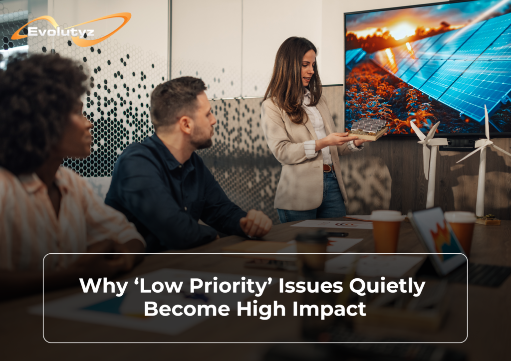 Team in a meeting, unaware of the low priority issue about to become their biggest problem.